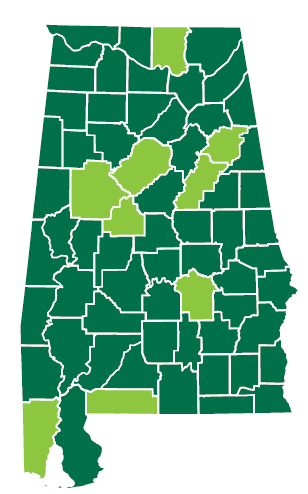A map of Alabama counties in a dark green with some coutnies highlighte in light green